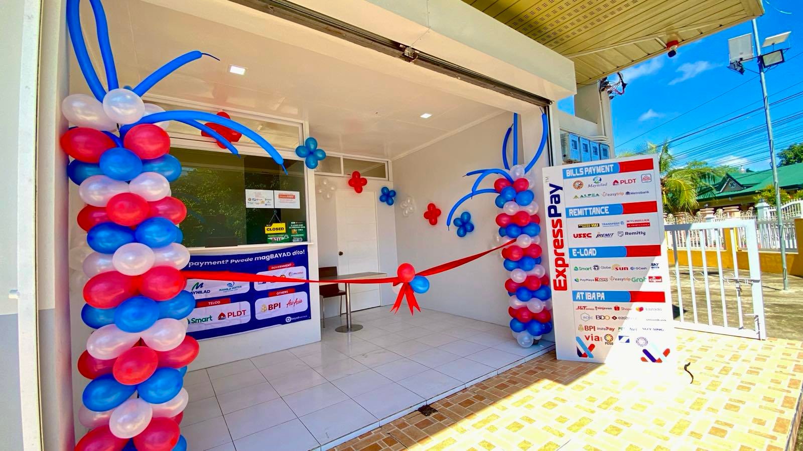 ExpressPay branch grand opening with ribbon and decorations
